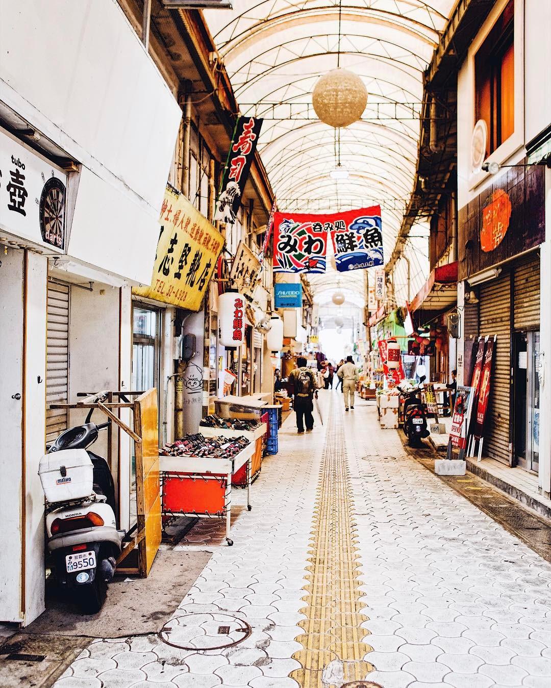 walkway of vendors and signs