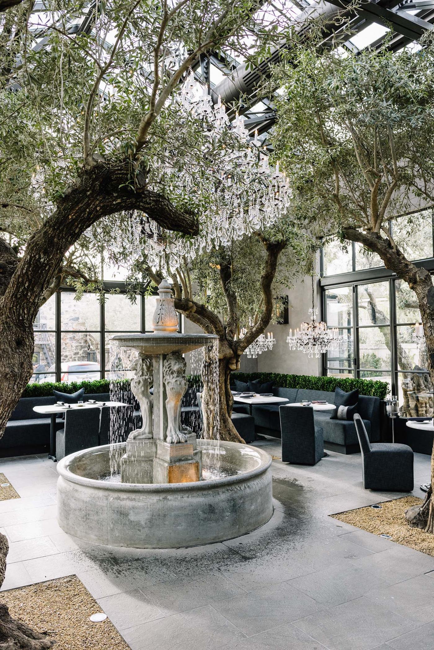 restaurant setting with trees and fountain