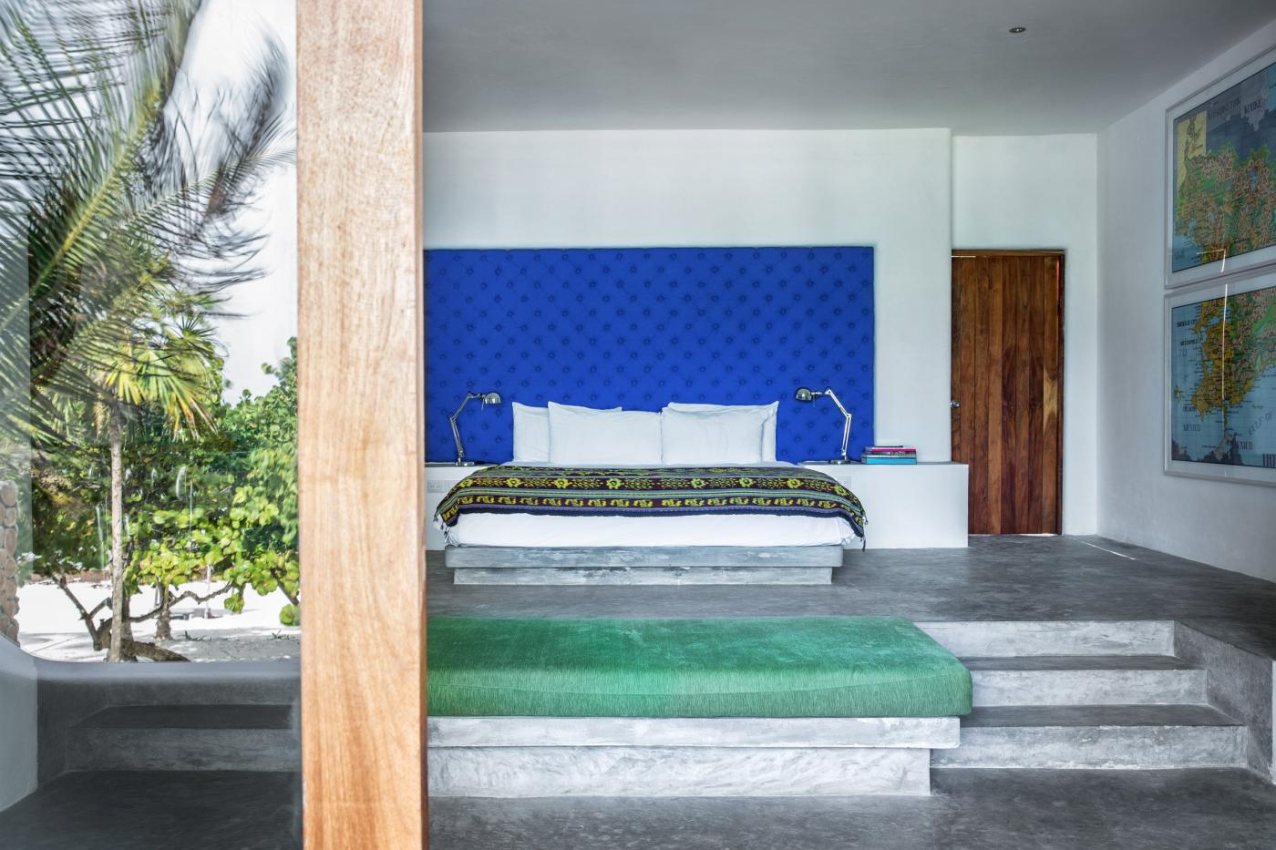 luxury hotel room with staircase up to bed