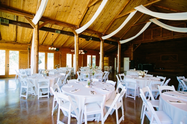 Exposed wooden beams and high ceilings to hang draping and lighting.