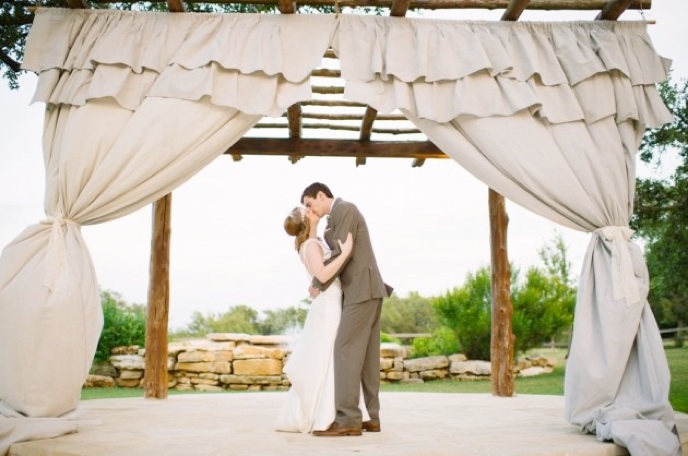 Fabric draped on ceremony arbor.