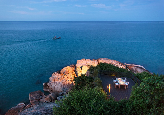 Host a private dinner party in Thailand surrounded by candles and the ocean.