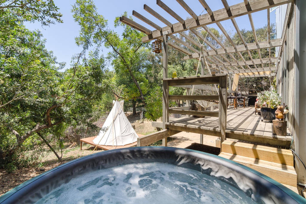 Enjoy the deck and hot tub day or night.