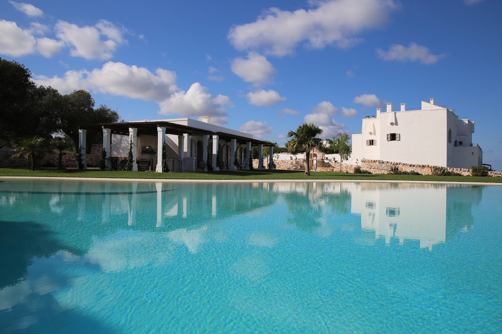 The main pool sits next to the pool house and close to the house, yet blends into its surroundings.