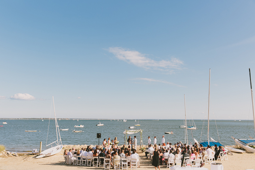 Beach Ceremony with boats in the background.