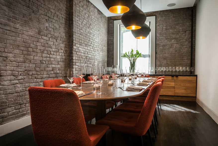 Tucked away in the restaurant, the private dining room includes a handcrafted, custom-built walnut table and bespoke chairs made of vintage fabric.