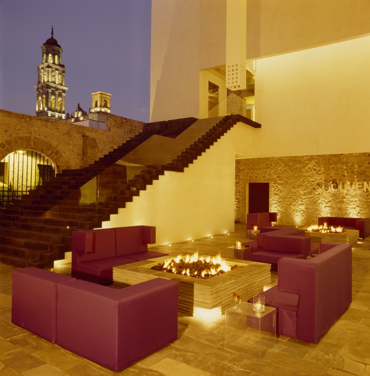 Gather around the fireplace and enjoy views of the Puebla cityscape at night.
