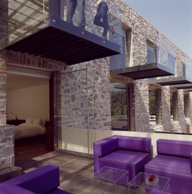 Modern minimalism mingles with the rustic architecture of the original building.