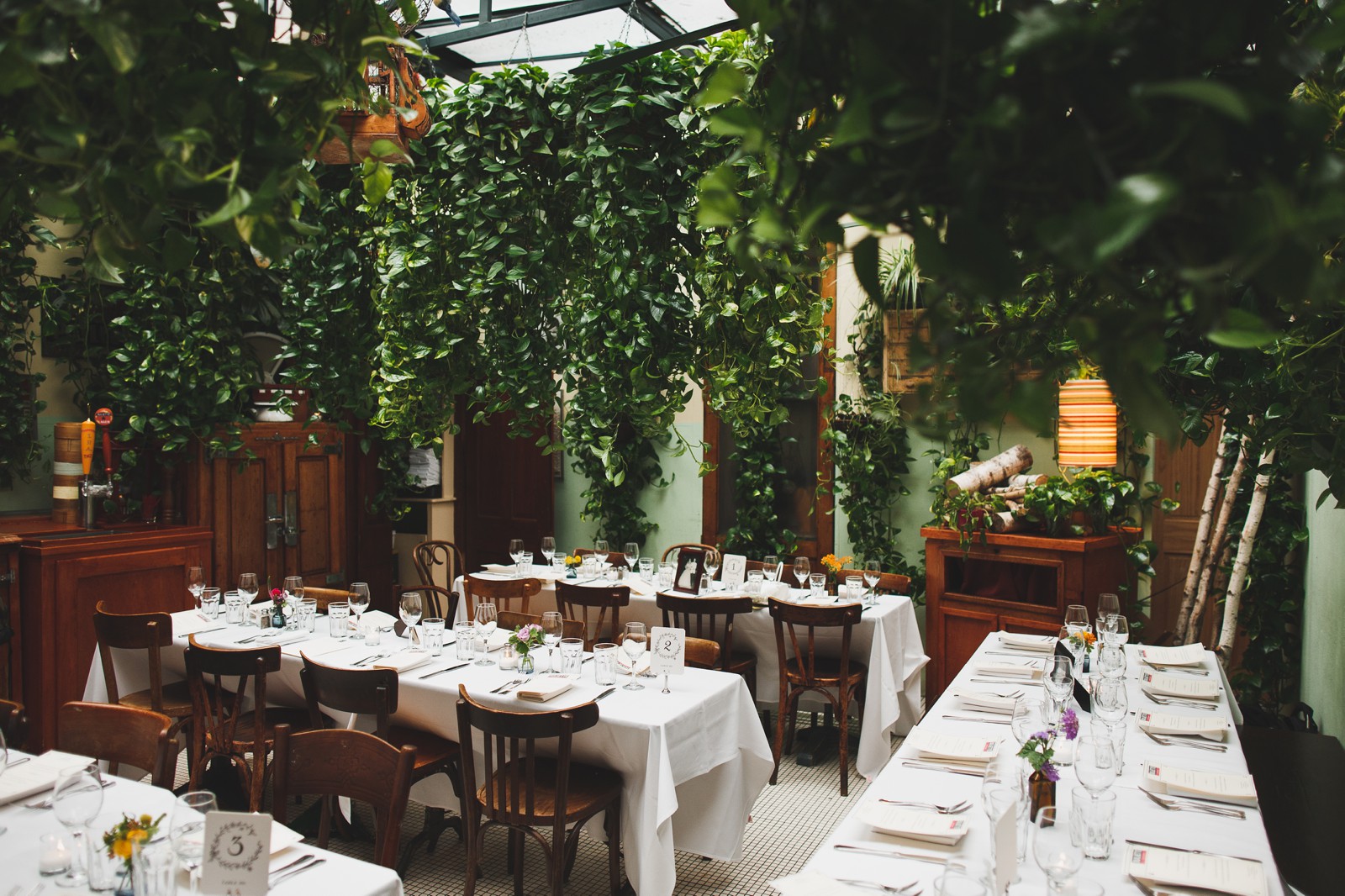 The main dining room offers romantic nooks, lively bistro seating and extravagant greenery.