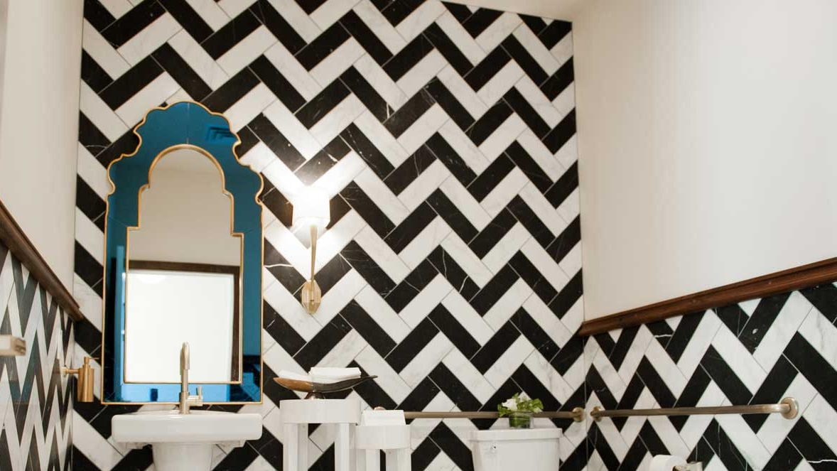 Every design detail from the black and white marble herringbone in the restrooms to the Tiffany green patina outdoor bar ceiling is a component of the unique space.