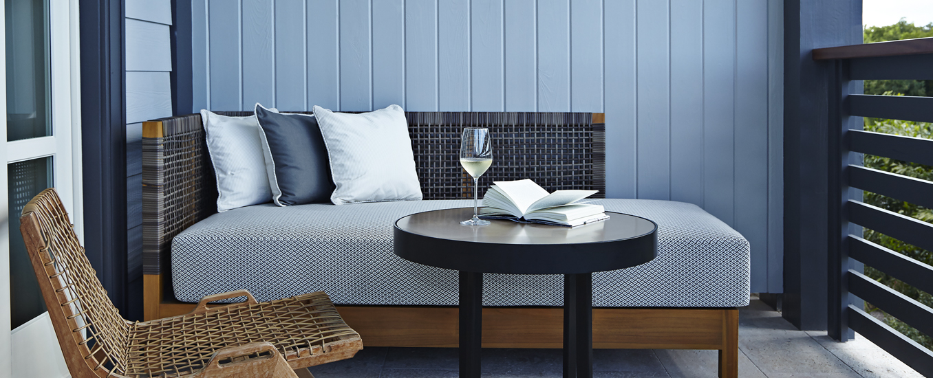 Grab a glass of wine and read a book on your private balcony.