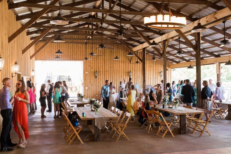 This former equipment barn has been transformed into the perfect rustic and informal wedding reception space, complete with stage and dance floor, adjustable lighting options, ceiling fans and lawn area.