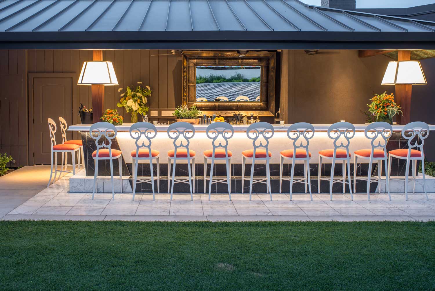 The large outdoor bar is bold and sophisticated, topped with white marble.