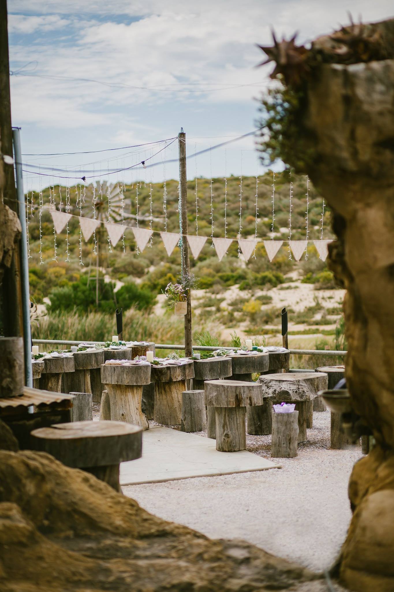 The open air part of the restaurant nestles against ancient rock formations and overlooks the Jackals Creek seasonal river and the natural field.