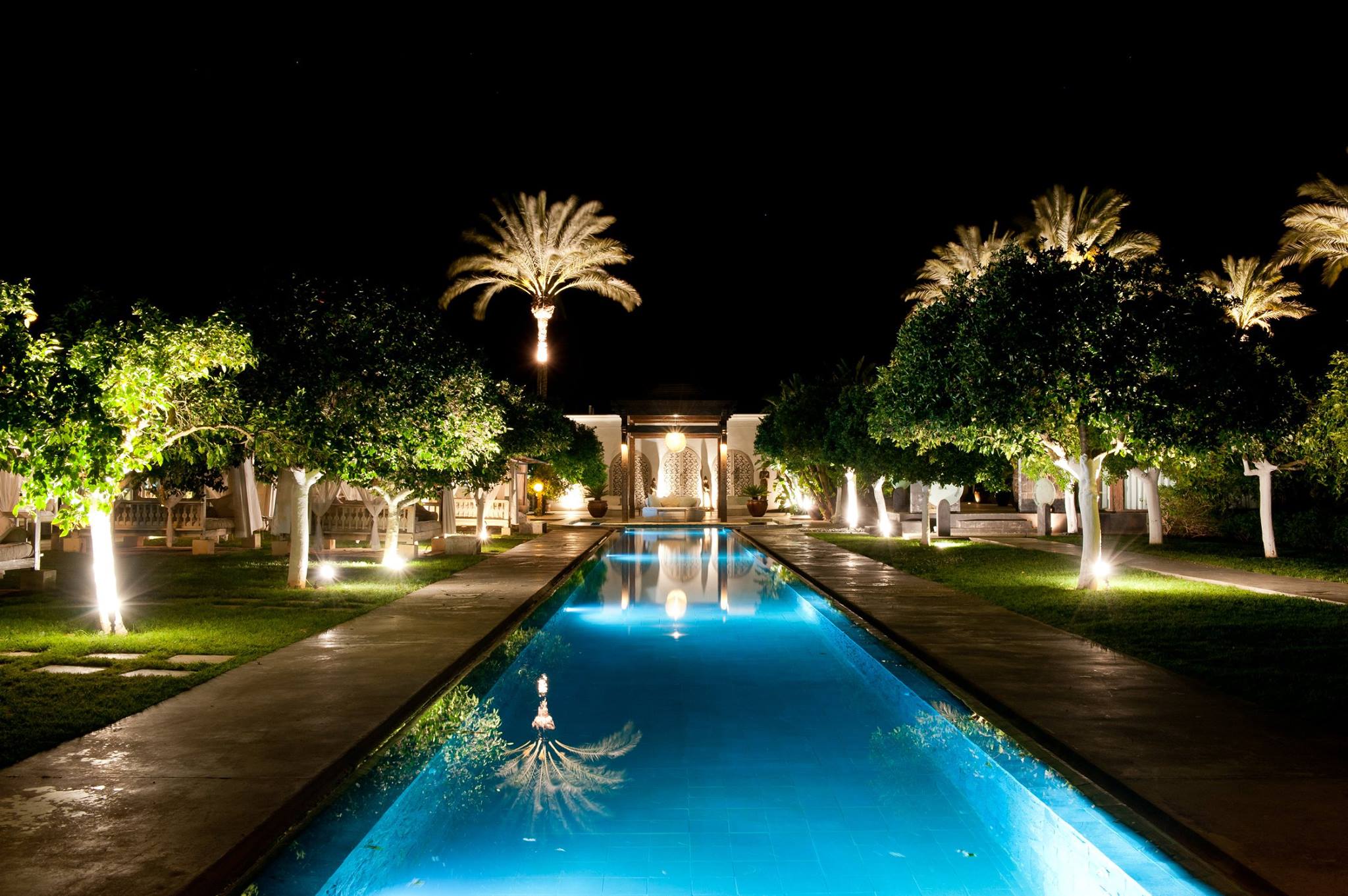 The swimming pool nicely lit at night.
