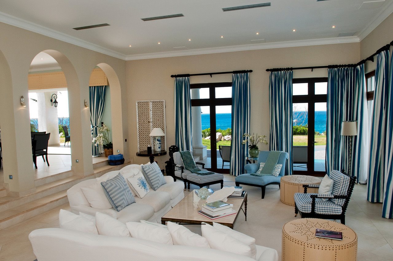 Architectural details include floor-to-ceiling windows, graceful archways, teak accents and Italian marble flooring.