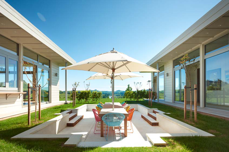 Two separate outdoor living spaces and one open fire.