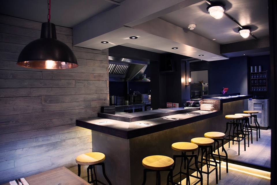 Diners can sit around the chefs' pass and interact with the chefs as they cook and plate up an array of sharing plates.