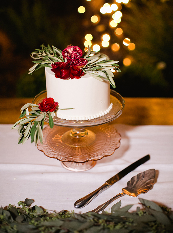 Wedding cake adorned with flowers.