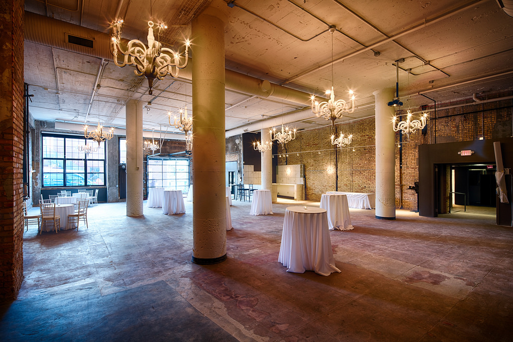 Elegant hanging chandeliers add a nice touch to the space.