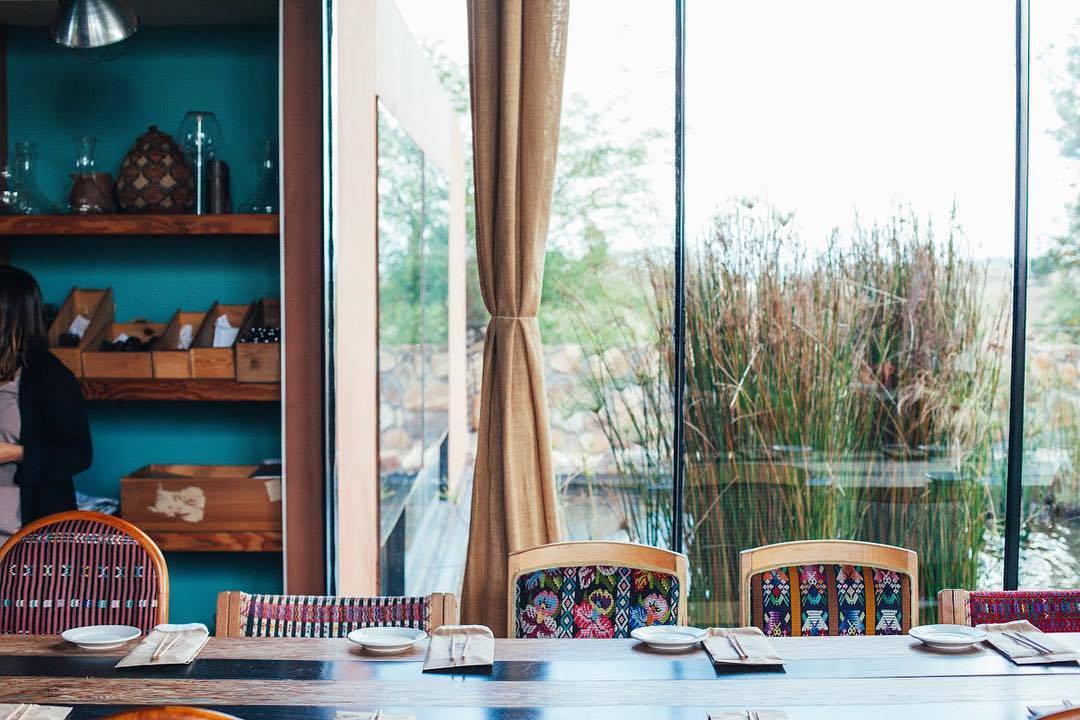 Fun mismatched chairs in the dining space.