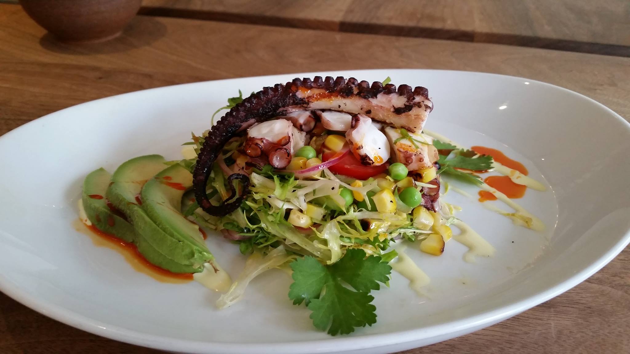Octopus, avocado, corn, tomatoes and yuzu emulsion.