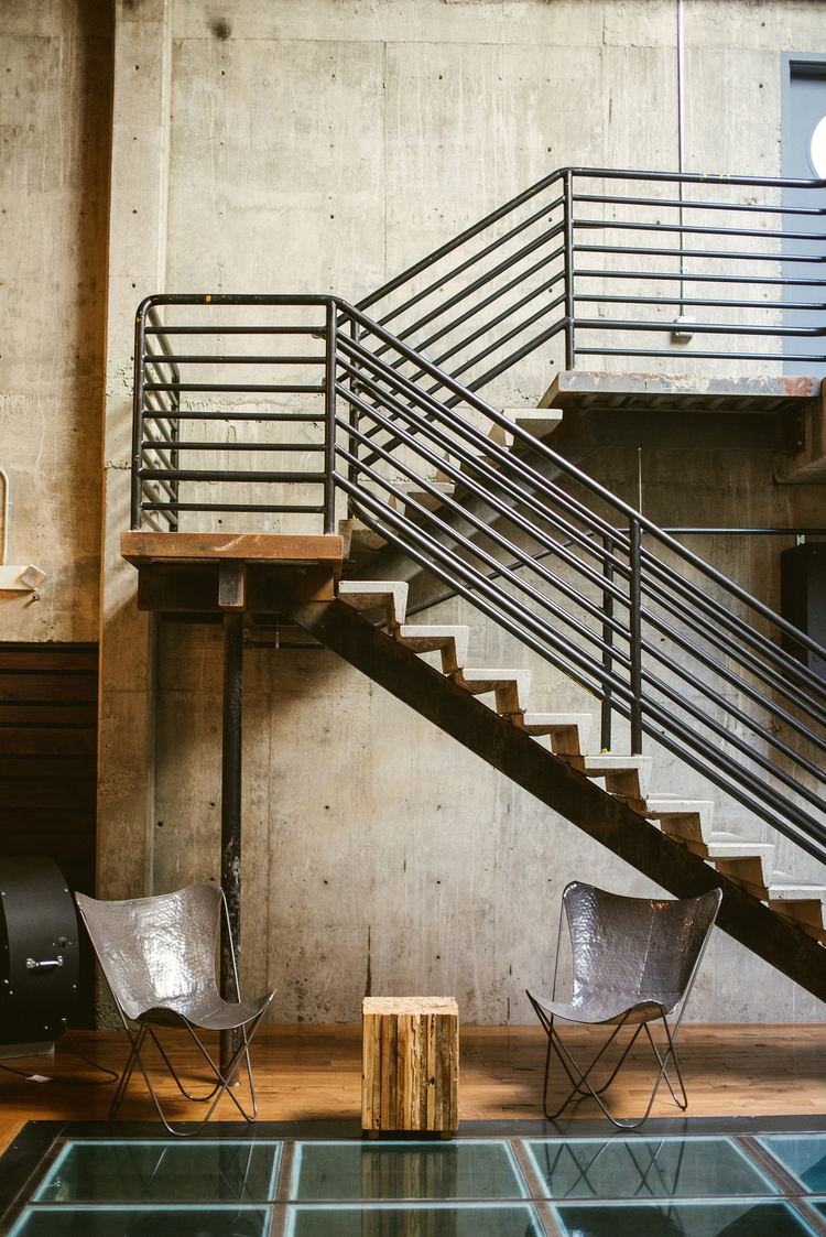 Preserving the origins of a working foundry, the main atrium has a 20-foot oak ceiling with exposed steel beams, a sky-lit cement wall, surrounding mezzanine walkway & Juliet balcony, oversized industrial doors, and rich hardwood flooring.