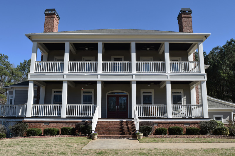 Built as the centerpiece to this traditional Southern homestead, is a breathtaking 3 story home featuring a 2 story front porch, an indoor basketball/racketball court, an in-ground swimming pool, and 'getting ready' suites.
