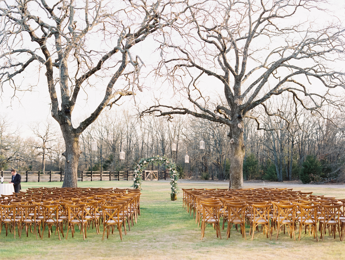 The white barn’s rustic charm is breathtaking in its idyllic natural setting amidst impressive oaks and lush gardens.