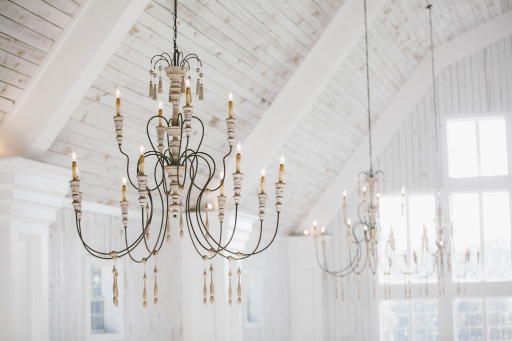 Whitewashed beams and beautiful chandeliers make this space so unique and breathtaking.