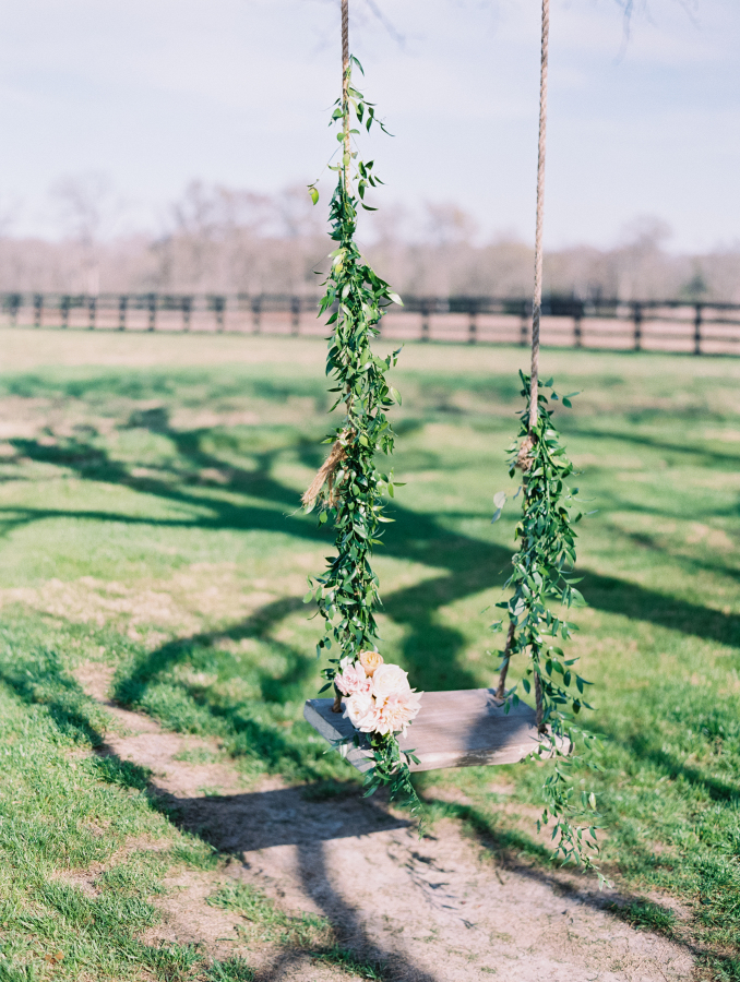 Down-home Texas charm nestled in a field surrounded by flower gardens a grove and a sweet swing.