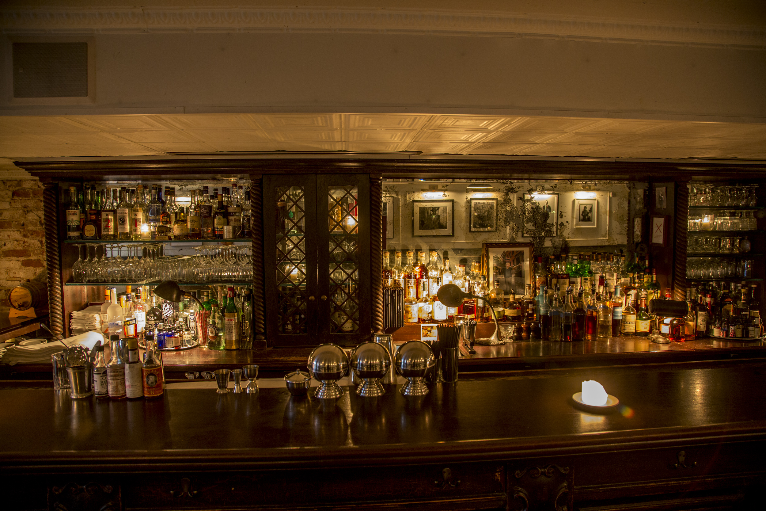 Hip hop photography adorns the walls and a beautiful large bar dominates the room.