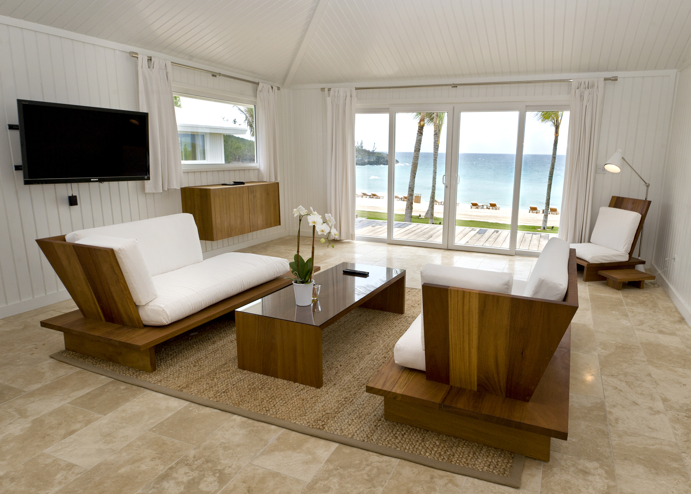 The Main Building features sand-colored tile floors, white washed walls with airy white sheers and island-chic furnishings.