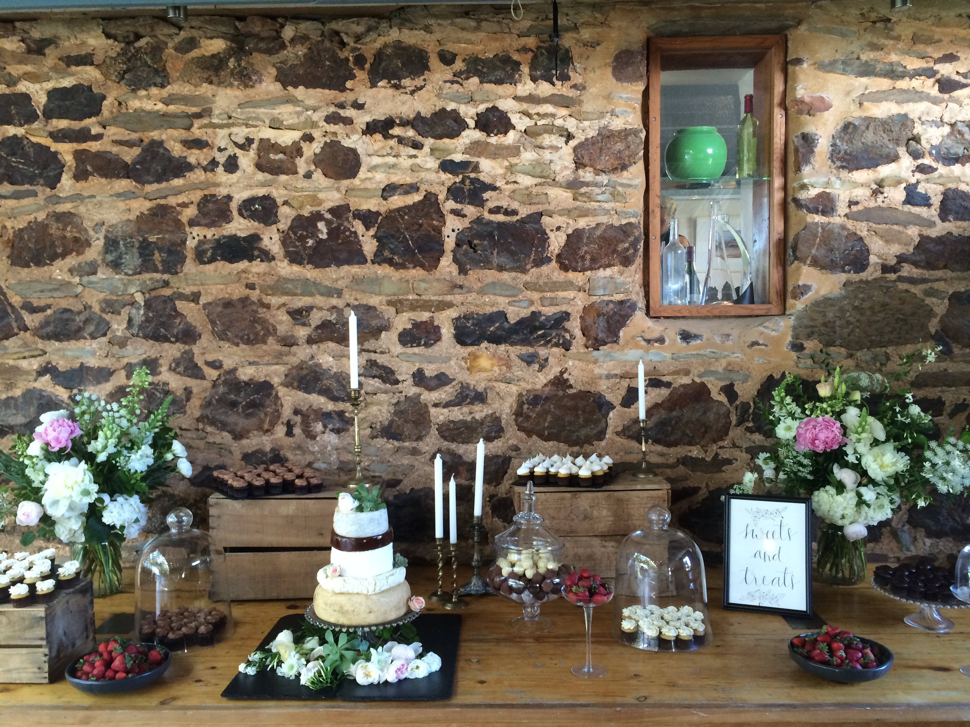 Dessert table against the stone walls.