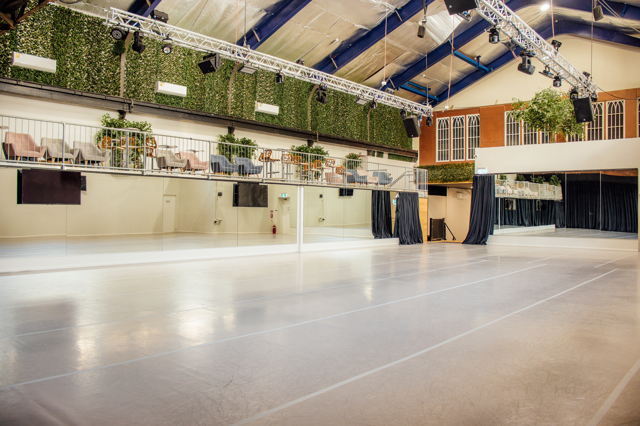The Gantry Room - Black drapes open to reveal mirrored walls, with Tarkett Flooring
