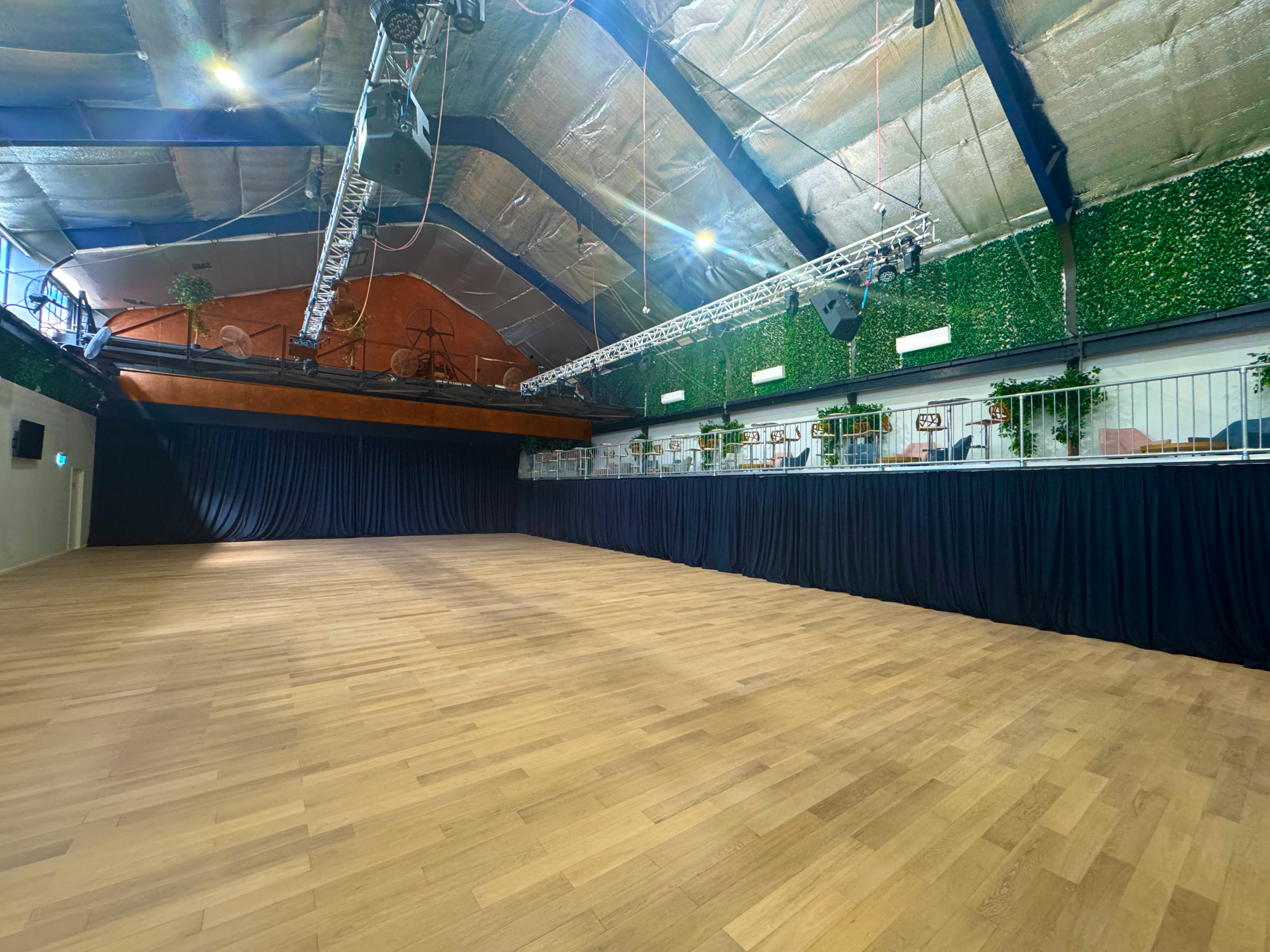 The Gantry Room - Hardwood floor with drapes & Mezzanine