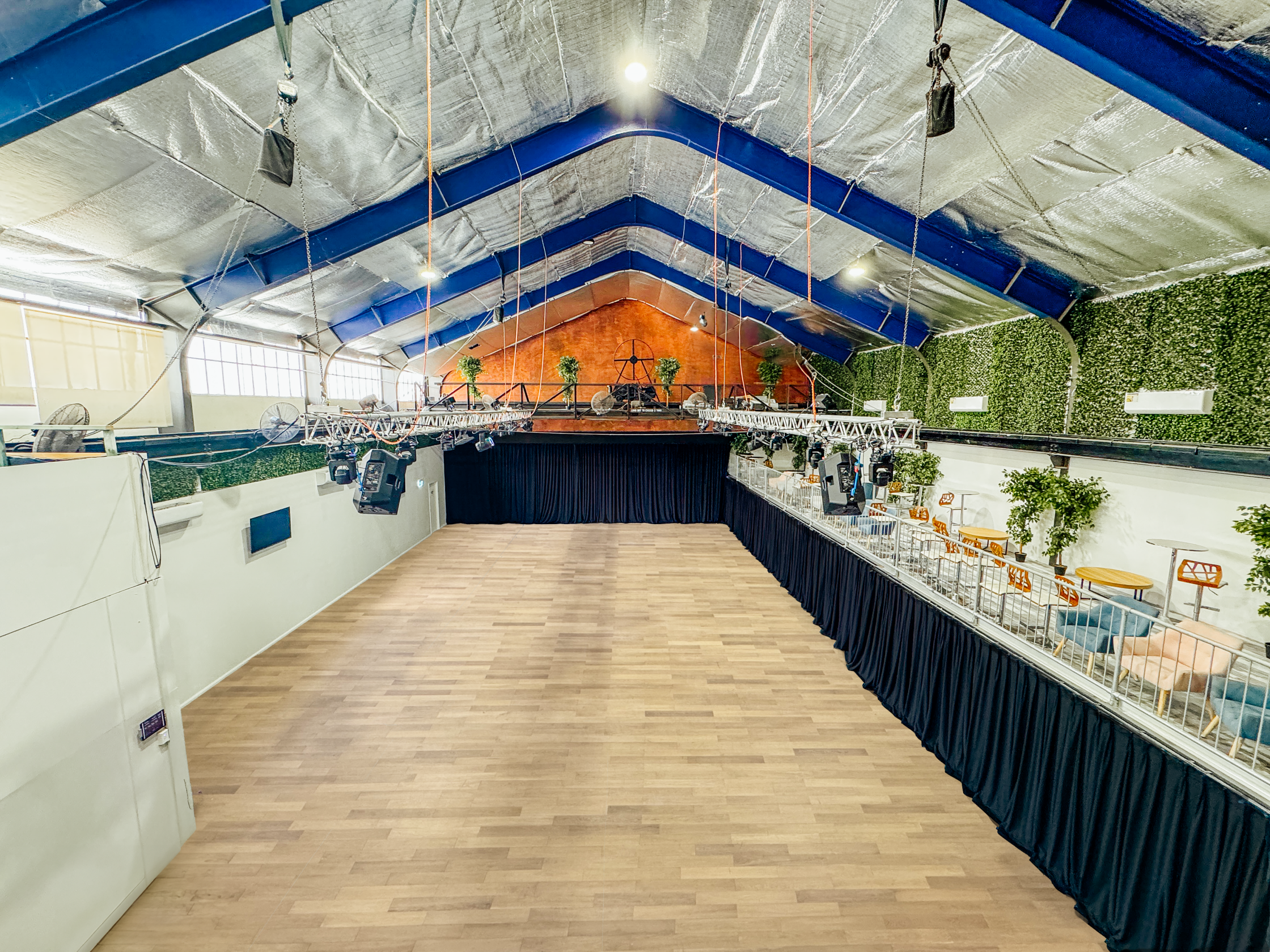 The Gantry Room - Hardwood floor with drapes & Mezzanine