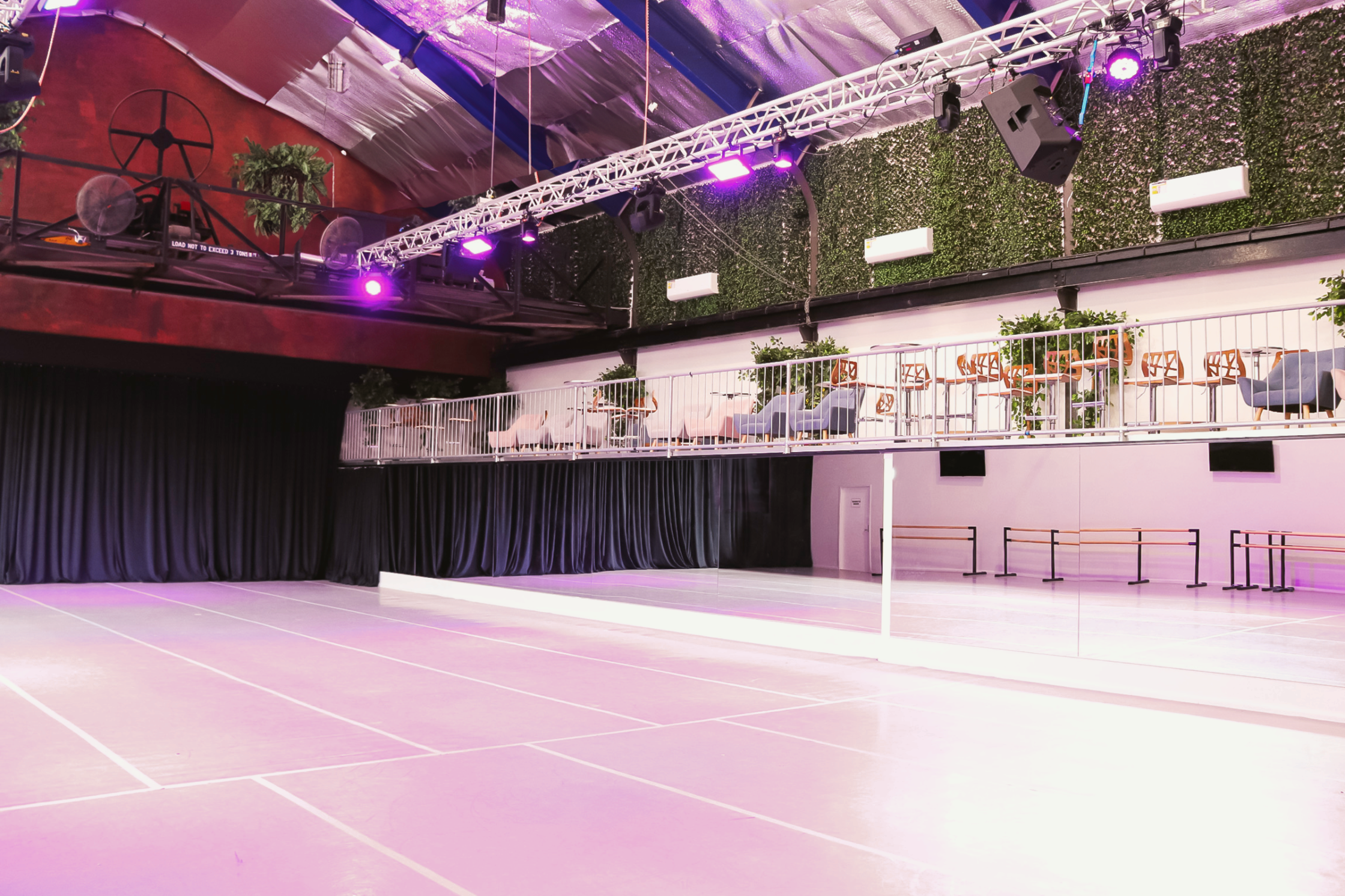 The Gantry Room - Black drapes open to reveal mirrored walls, with Tarkett Flooring