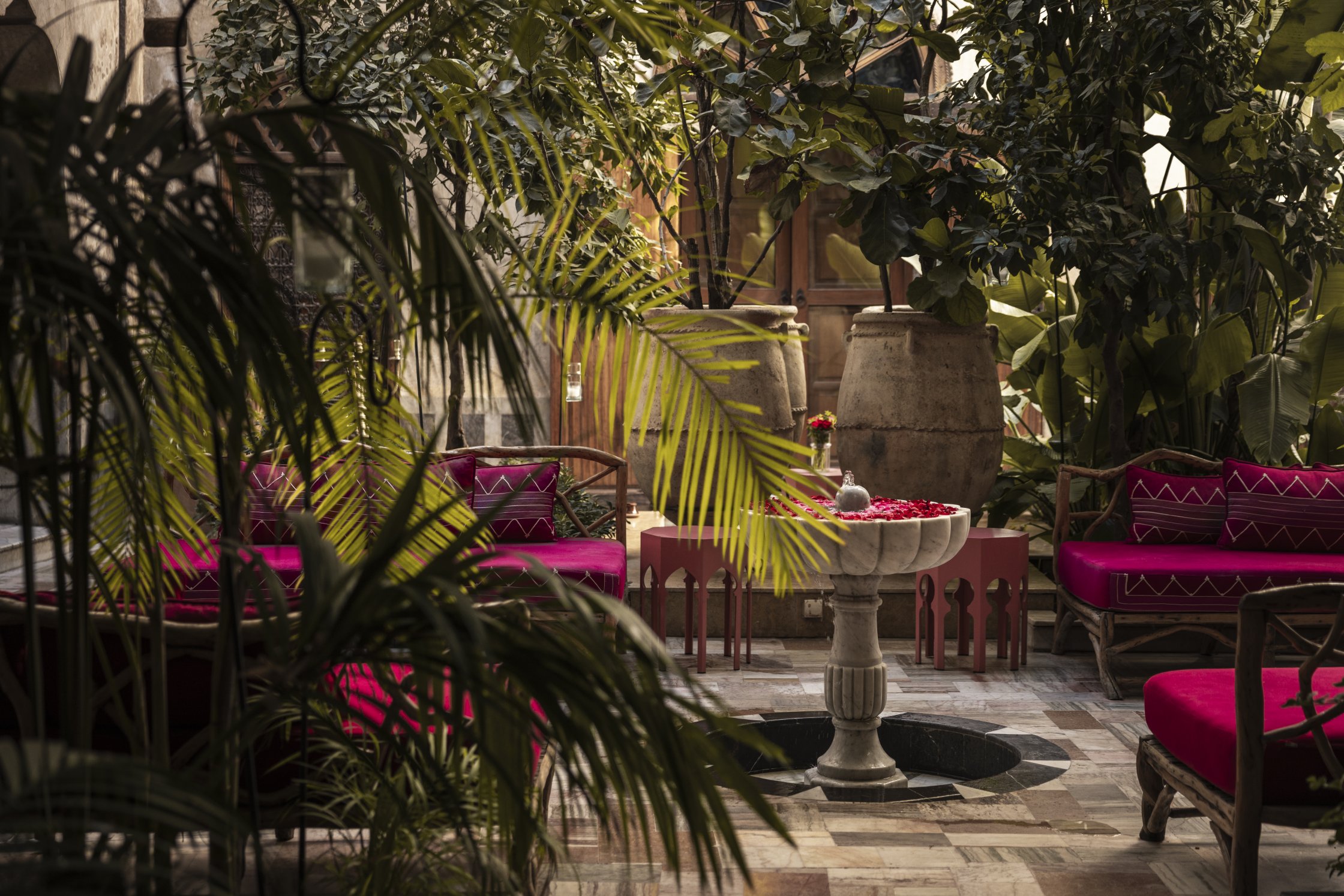 Tree lined courtyards with rose petal fountains and cushion clad daybeds.