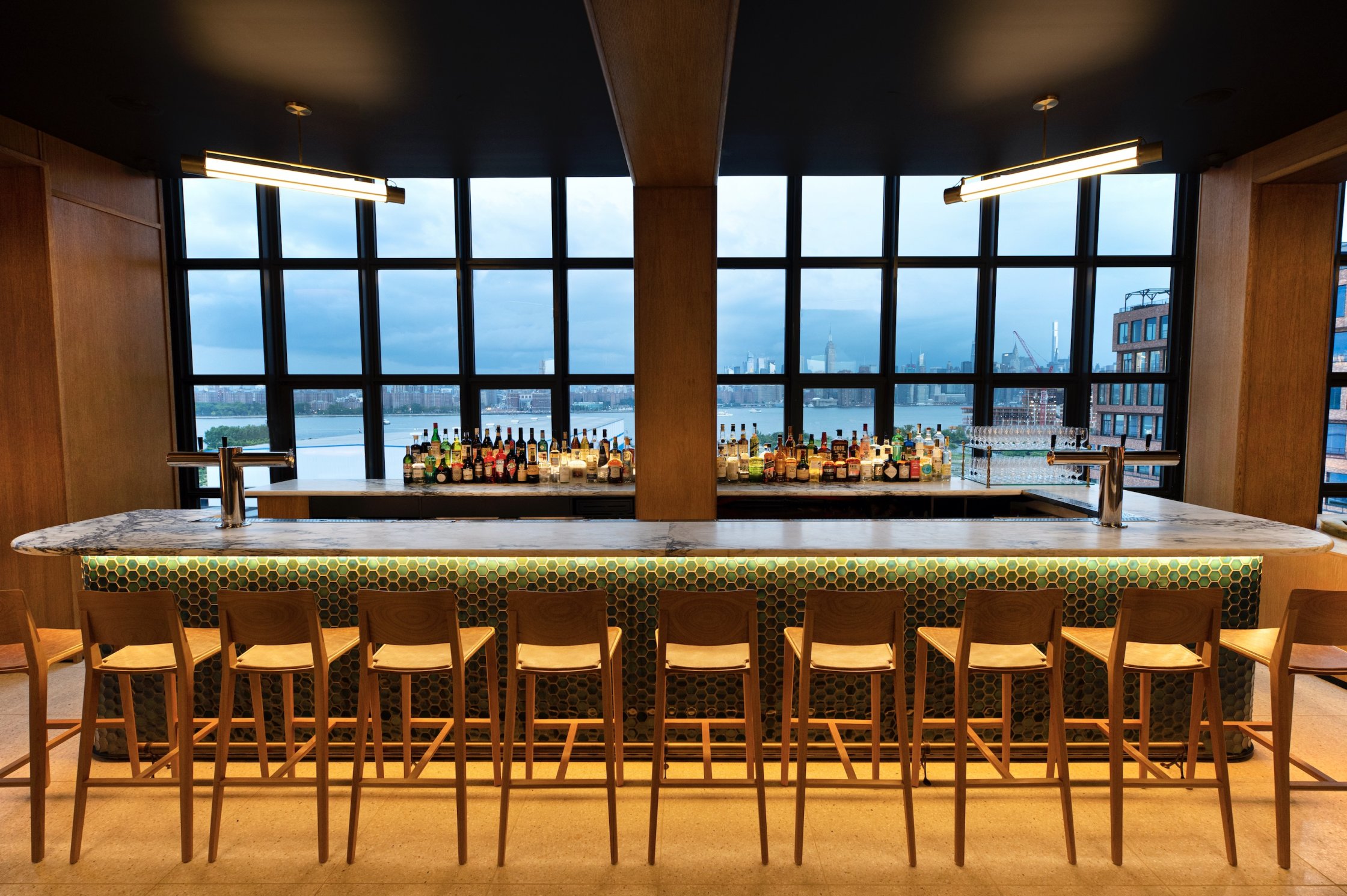 Bar Blondeau is a 5,400-square-foot rooftop venue with unobstructed views of the Manhattan skyline. The space features a stylishly appointed lounge with floor-to-ceiling windows for indoor seating year-round, along with an expansive wraparound terrace for